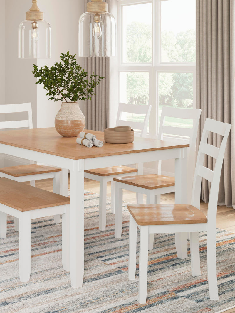 Ashley Furniture Gesthaven dining table with four chairs and a bench, featuring a sturdy wooden design for family meals.