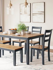 Ashley Furniture Gesthaven dining table with four chairs and a bench, showcasing a stylish wood finish and modern design.