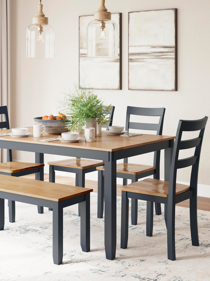 Ashley Furniture Gesthaven dining table with four chairs and a bench, showcasing a stylish wood finish and modern design.