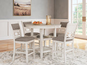 Ashley Furniture Erinberg counter height dining table with four matching barstools, showcasing a modern wood finish and sturdy design.