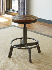 Ashley Furniture Torjin counter height dining set with a table and matching chairs in a modern dining room setting.