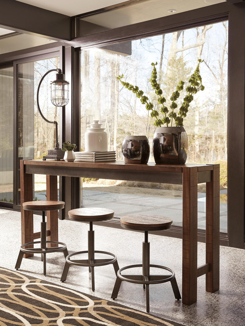 Ashley Furniture Torjin counter height dining set with four chairs and a rectangular table in a modern dining room setting.