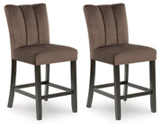 Ashley Furniture Jeshina counter height barstool with wooden legs and cushioned seat, shown from an angled side view.