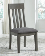 Ashley Furniture Hallanden dining room set with a wooden table and matching chairs in a modern dining space.