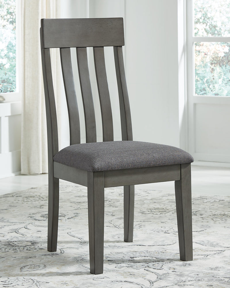 Ashley Furniture Hallanden dining room set with a wooden table and matching chairs in a modern dining space.