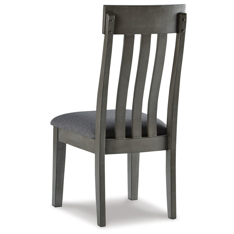 Back view of the Ashley Furniture Hallanden Dining Room Set, showcasing the wooden table and matching chairs.