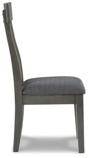 Ashley Furniture Hallanden Dining Room Set with a wooden table and six matching chairs in a modern dining space.