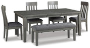 Ashley Furniture Hallanden dining room set with a wooden table and six matching chairs in a modern dining space.