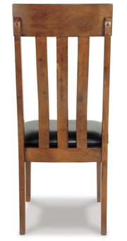 Ashley Furniture Ralene Dining Chair Set with cushioned seats and dark wooden legs, shown from the back angle.