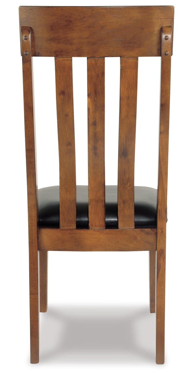 Ashley Furniture Ralene Dining Chair Set with cushioned seats and dark wooden legs, shown from the back angle.