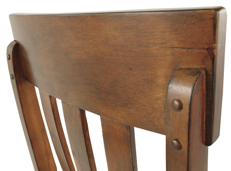Ashley Furniture Ralene Dining Chair Set featuring upholstered seats and wooden legs, shown in a close-up detail image.