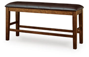 Ashley Furniture Ralene counter height dining bench with wooden legs and upholstered seat, angled view showing comfortable design.
