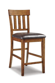 Set of four Ashley Furniture Ralene barstools with wooden seats and metal legs, arranged around a modern kitchen island.