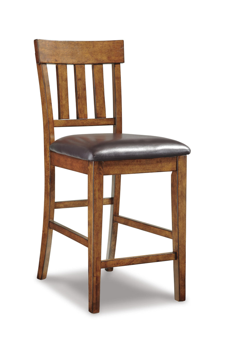 Set of four Ashley Furniture Ralene barstools with wooden seats and metal legs, arranged around a modern kitchen island.