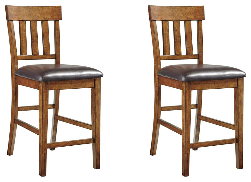 Set of Ashley Furniture Ralene Bar Stools showing dark wood finish and cushioned seats with backrests.