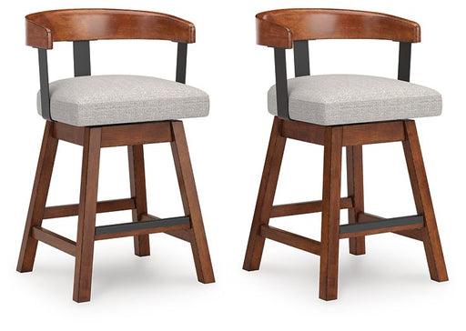Set of two Ashley Furniture Ralene counter height barstools with wooden legs and cushioned seats, angled view.