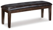 Ashley Furniture Haddigan dining bench with wooden legs and upholstered seat, ideal for modern dining room decor.