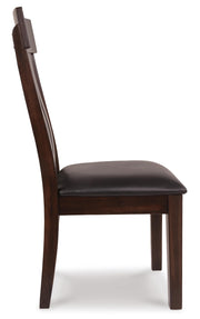 Ashley Furniture Haddigan dining chair with wooden legs and upholstered seat, shown from a side view.