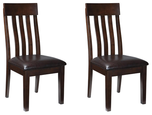 Ashley Furniture Haddigan dining chair set with upholstered seats and dark wood legs, shown in a modern dining room setting.