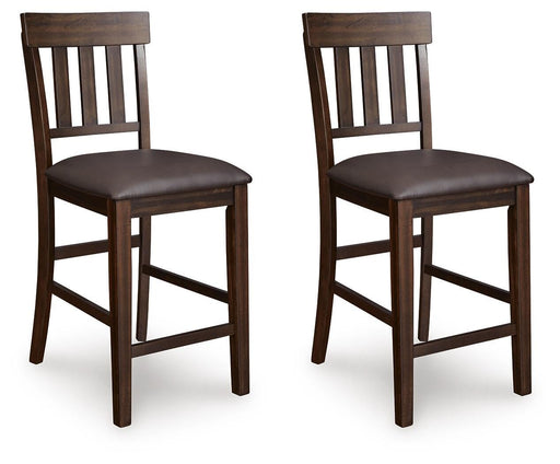 Ashley Furniture Haddigan counter height bar stool with wooden legs and a cushioned seat, shown from an angled side view.