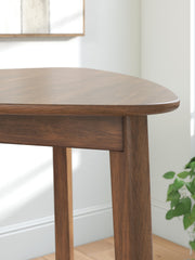 Close-up of the Ashley Furniture Tameride dining table showing its wood grain and detailed design features.