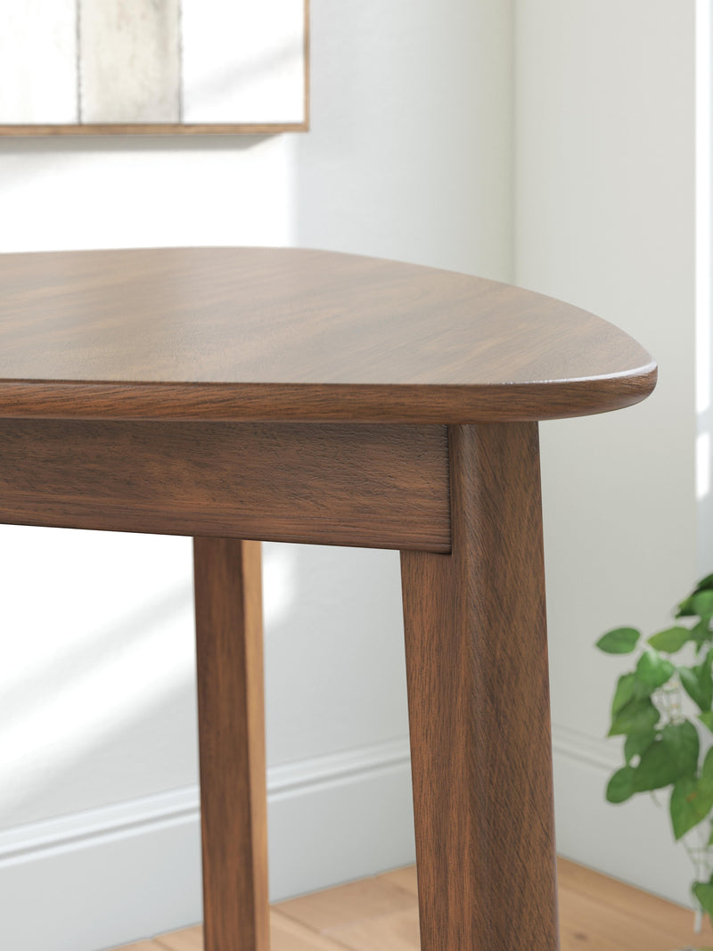 Close-up of the Ashley Furniture Tameride dining table showing its wood grain and detailed design features.