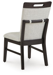 Ashley Furniture Neymorton dining room set with a table and chairs, shown from the back view in a modern dining space.