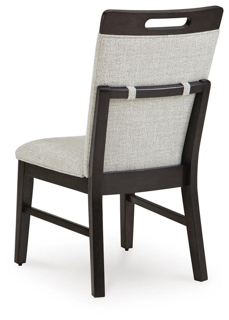 Ashley Furniture Neymorton dining room set with a table and chairs, shown from the back view in a modern dining space.