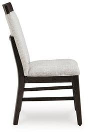 Ashley Furniture Neymorton dining room set with a wooden table and matching chairs, shown from a side view in a well-lit dining space.