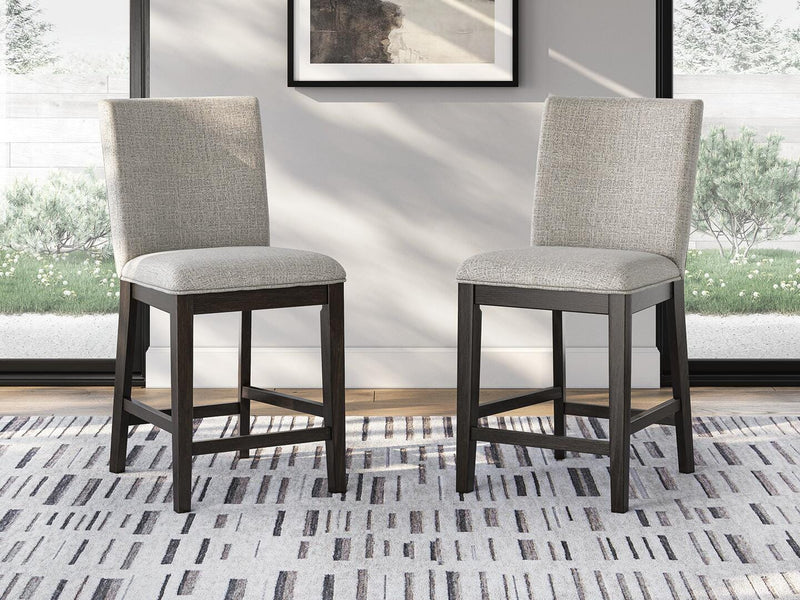 Ashley Furniture Neymorton counter height barstool with wooden legs and upholstered seat, shown from a side angle.