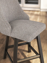 Pair of Ashley Furniture Neymorton counter height barstools with wooden seats and metal legs, set of 2, shown from the side.