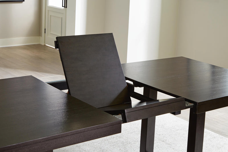 Ashley Furniture Neymorton dining room set with a leaf-patterned table and matching chairs, showcasing elegant wood finish and detailed design.