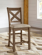 Ashley Furniture Moriville counter height dining set with a table and matching chairs in a modern dining room.
