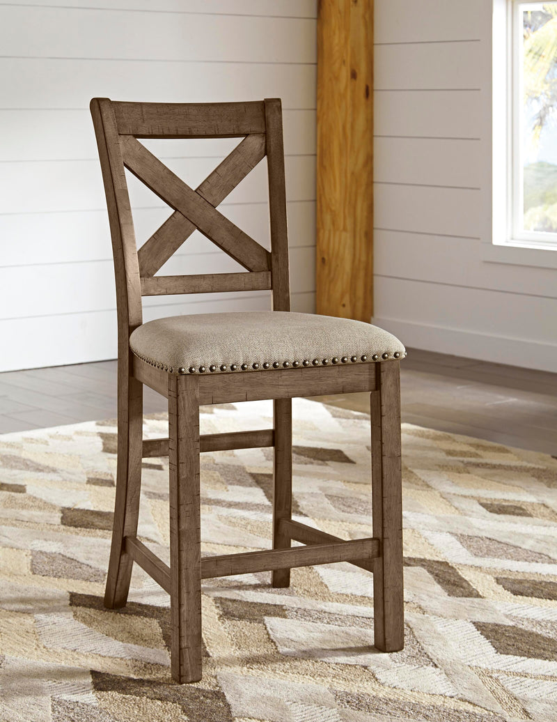 Ashley Furniture Moriville counter height dining set with a table and matching chairs in a modern dining room.