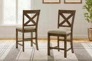 Ashley Furniture Moriville counter height dining set with a wooden table and matching chairs in a warm finish.