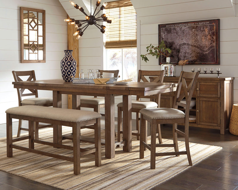 Ashley Furniture Moriville counter height dining set with a round table and four upholstered chairs in a modern dining room setting.