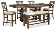 Ashley Furniture Moriville counter height dining set with dark wood table and matching upholstered chairs in a modern dining room.