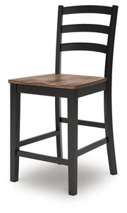 Ashley Furniture Wildenauer counter height barstool with wooden legs and upholstered seat, shown from an angled side view.