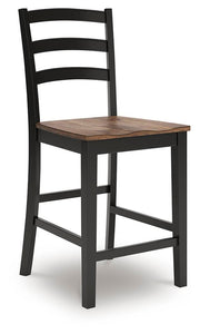 Ashley Furniture Wildenauer counter height barstool with wooden frame and upholstered seat, shown from an angled side view.