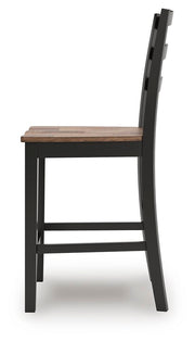 Side view of Ashley Furniture Wildenauer counter height barstool with wooden legs and a cushioned seat in a modern design.