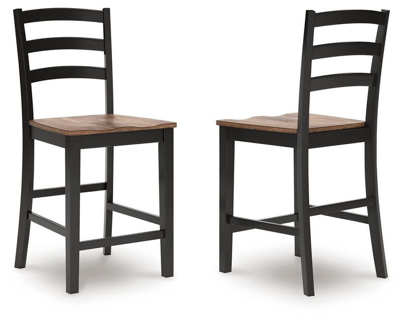 Ashley Furniture Wildenauer counter height barstool with wooden legs and a cushioned seat, shown from an alternate angle.