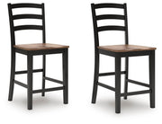 Ashley Furniture Wildenauer counter height barstool with a wooden frame and cushioned seat, shown from an angled side view.