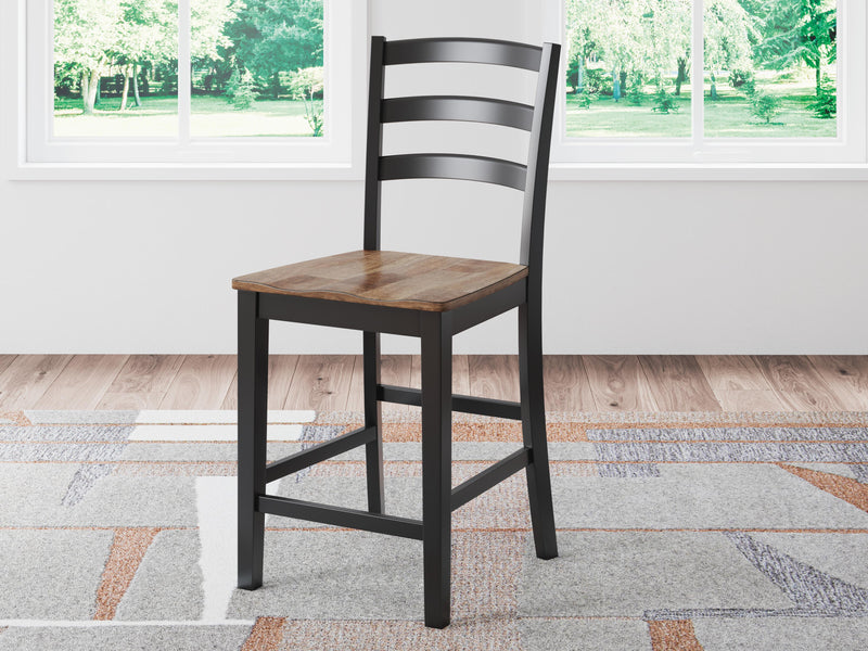 Ashley Furniture Wildenauer counter height barstool with wooden frame, cushioned seat, and backrest, perfect for kitchen or bar area.