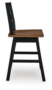 Side view of Ashley Furniture Wildenauer counter height swivel barstool with wooden legs and cushioned seat.