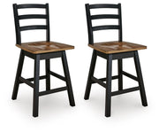 Ashley Furniture Wildenauer counter height swivel barstool with wooden legs and cushioned seat, shown from an angled side view.