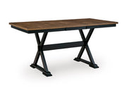 Ashley Furniture Wildenauer counter height butterfly extension table with angled view showing wood finish and expandable tabletop.
