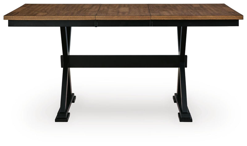 Wildenauer counter height butterfly extension table by Ashley Furniture, showing the table's wood surface with extended leaf in view.