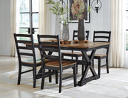 Ashley Furniture Wildenauer casual dining set with leaf-patterned table and chairs, perfect for outdoor or casual dining spaces.