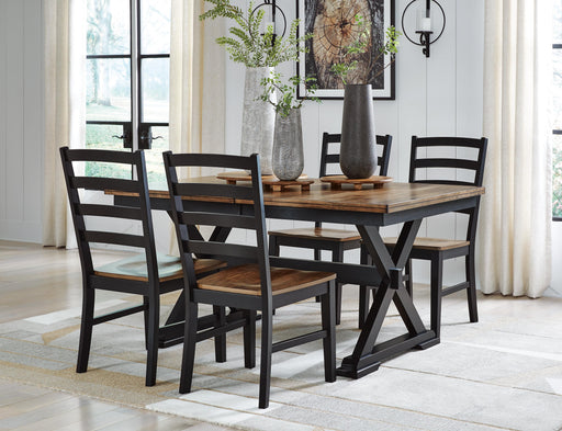 Ashley Furniture Wildenauer casual dining set with leaf-patterned table and chairs, perfect for outdoor or casual dining spaces.