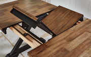 Ashley Furniture Wildenauer Casual Dining Set with leaf-patterned fabric and four matching chairs arranged around a wooden table.